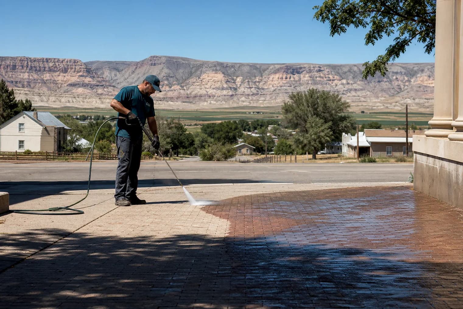 Exterior-cleaning scene inspired by Hanksville, Utah, with characteristic central Utah landscape
