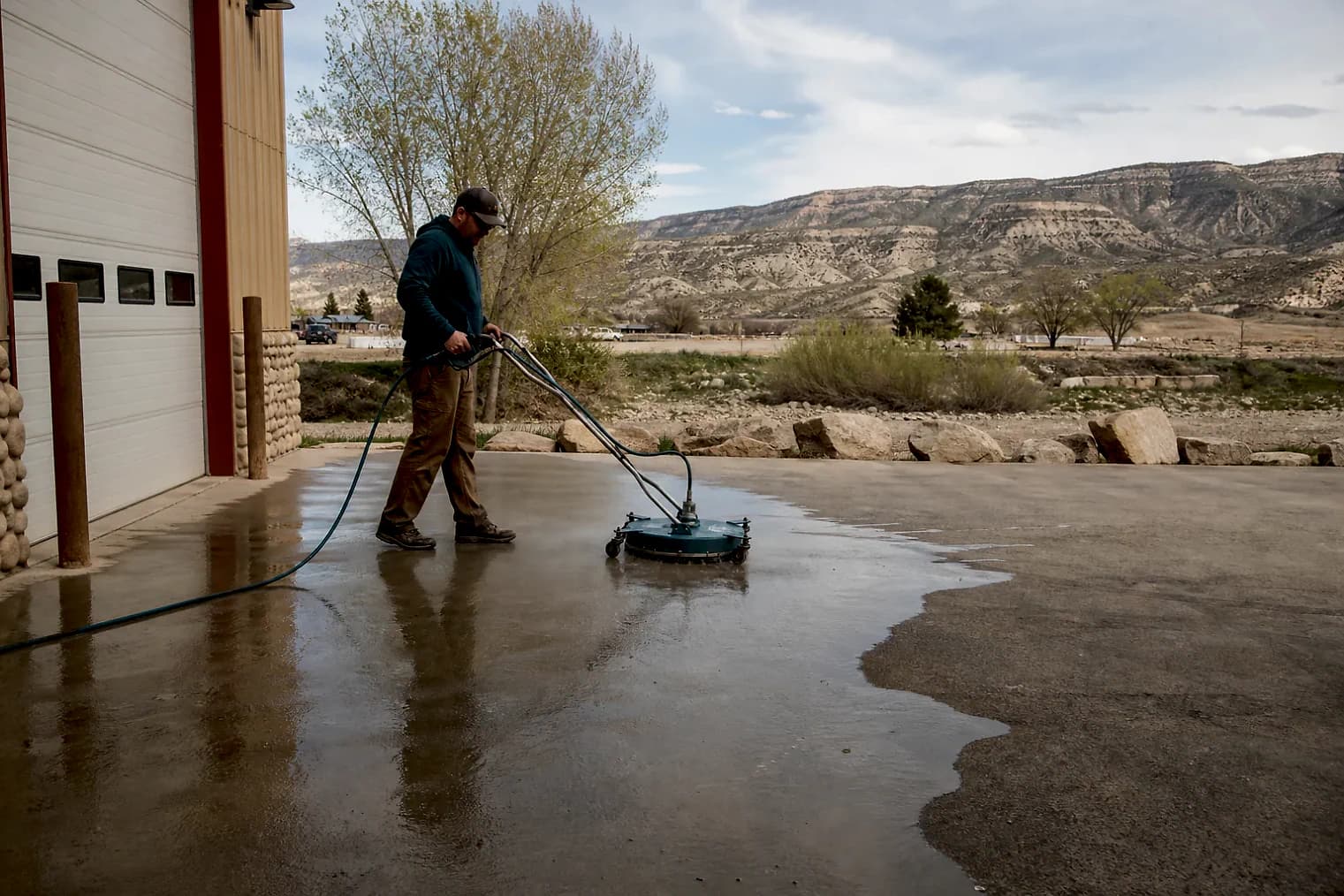 Exterior-cleaning scene inspired by Vernal, Utah, with characteristic the Uintah Basin landscape