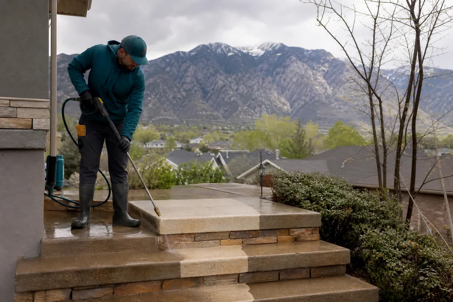 Exterior-cleaning scene inspired by White City, Utah, with characteristic the Wasatch Front landscape